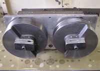 Custom fixture to hold a cast iron part that was turned on a CNC lathe. This fixture locates two parts to drill and tap a 1/4-28 hole in each.