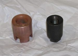Both parts are 4140 steel nuts that are heat treated to 48 Rc and one is copper electroplated.