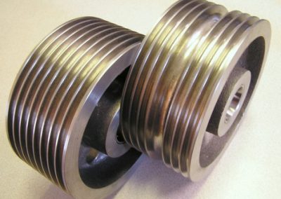 Cast iron cable sheave machined on a CNC lathe in two operations. Both parts are 8-1/2" diameter x 3-3/4 wide with different groove configurations.